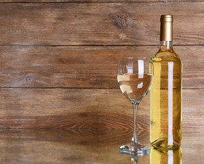 White wine on table on wooden background