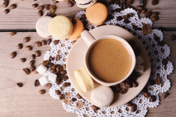 Gentle colorful macaroons and  coffee in mug