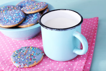 Plate of glazed cookies and mug of milk