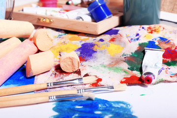 Professional art materials on color wooden background