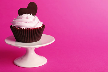 Delicious Valentine Day cupcake on pink background