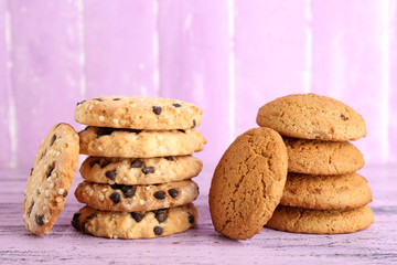 Tasty cookies on color wooden background