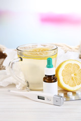 Hot tea for colds, pills and handkerchiefs