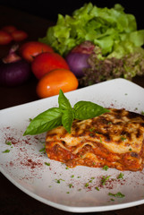 Lasagna on a square white plate