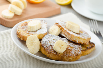 Obraz na płótnie Canvas French toast to sweet, with banana sprinkled with sugar