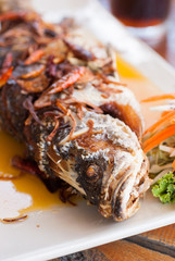 Fried fish with fresh herbs and sweet spicy sauce