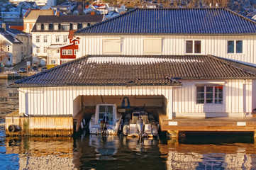 Fototapeta na wymiar Elegant white wooden garage for two luxury boats