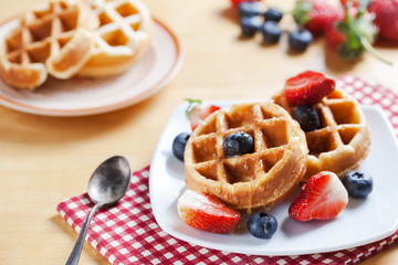 waffles with strawberry and blueberry and caramel sauce