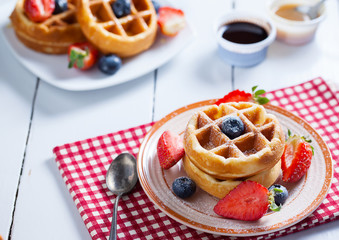 waffles with strawberry ,blueberry and caramel sauce