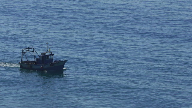 Fishing Boat Floating on the Ocean Waves, closeup
