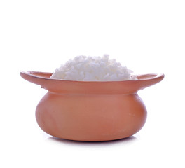 Rice in a clay pot on a white background