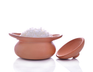 Rice in a clay pot on a white background