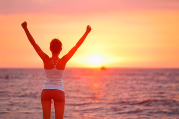 Happy cheering celebrating success woman sunset