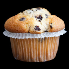 Light chocolate chip muffin in wax liner on black.