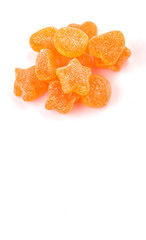 Orange colored sugar jelly candy over white background