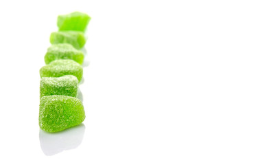 Green colored sugar jelly candy over white background