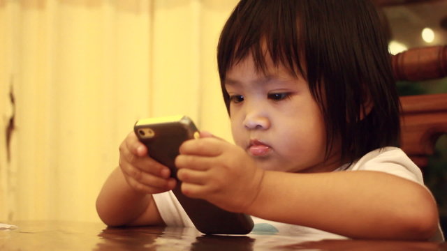 Asian Baby Looking Mobile Phone