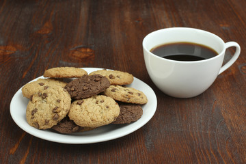 cookies and cup of hot coffee on wooden table