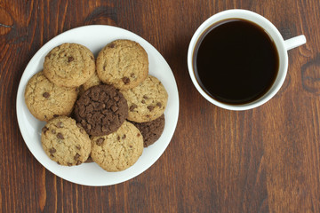 cookies and cup of hot coffee on wooden table