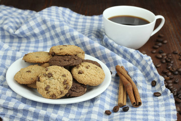 cookies and cup of hot coffee on old wooden table.