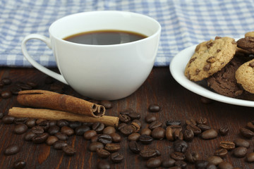cookies and cup of hot coffee on old wooden table.