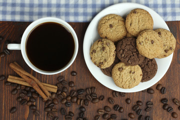 cookies and cup of hot coffee on old wooden table.