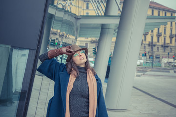 Fototapeta premium Beautiful young brunette posing in the city streets