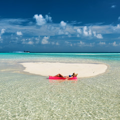Woman relaxing on inflatable mattress
