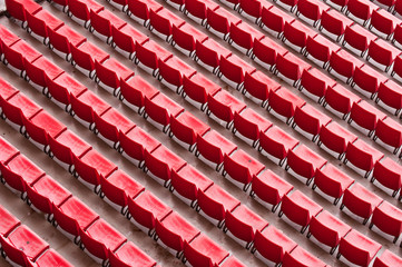 Empty ranges of red seats in a stadium