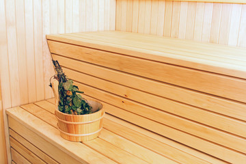 bucket with birch broom in sauna