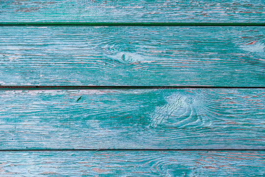 Old wooden planks with peeling green paint