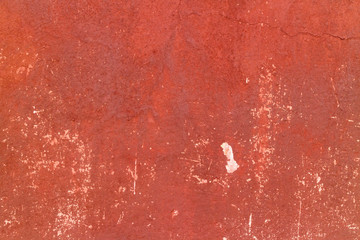 Crack red painted wall texture background.