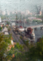 Autumn, rainy city through a window with raindrops.