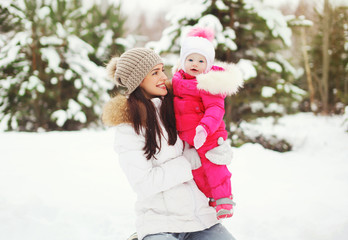 Happy family in winter snowy day