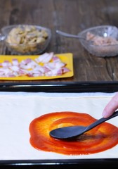 Preparing homemade pizza.