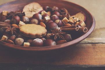 Clay display with gingerbread cookies, spices, nuts and sugar