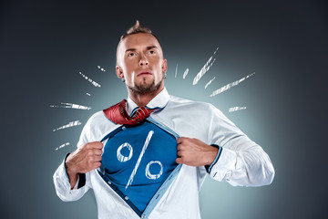 businessman acting like a super hero and tearing his shirt off