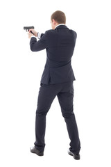 Fototapeta na wymiar back view of special agent man in business suit posing with gun