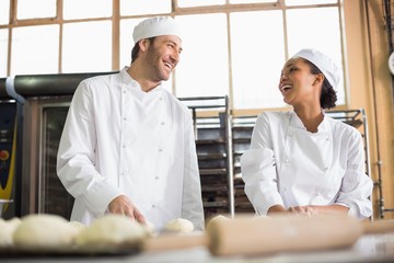 Team of bakers preparing dough