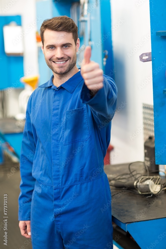 Poster mechanic smiling at the camera