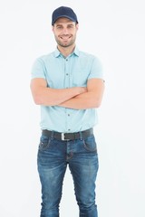Happy delivery man standing arms crossed