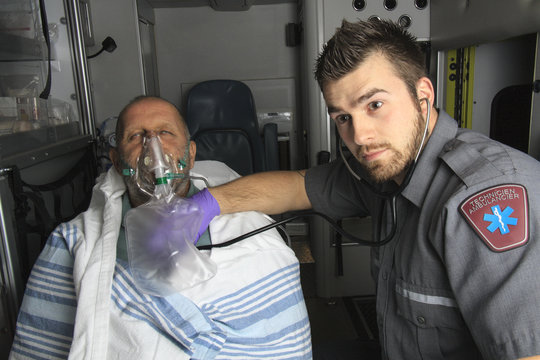 professional paramedics giving unconscious young woman first aid