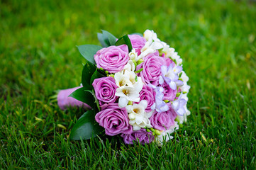 wedding bridal bouquet lying on the grass