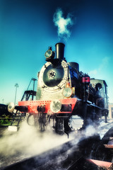 Obraz na płótnie Canvas Historical steam engine train in motion