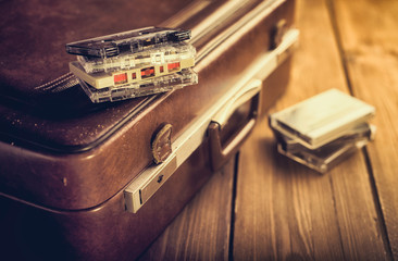 Cassette tape lying on an old suitcase. Vintage Retouching