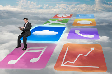 Manager using tablet sitting on shiny app icons with cloudscape