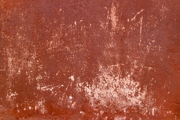 Crack red painted wall texture background.