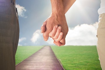 Composite image of happy senior couple holding hands