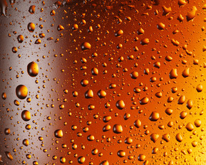 Water drops over beer glass.