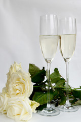 Champagne Glasses and Bunch of White Roses